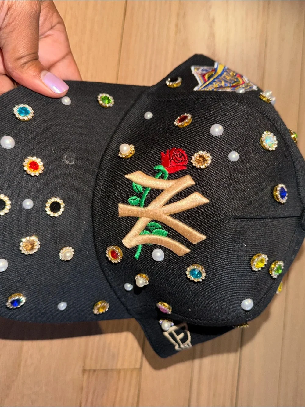 Embellished Black Baseball Cap with Gold Embroidered Rose Accent
